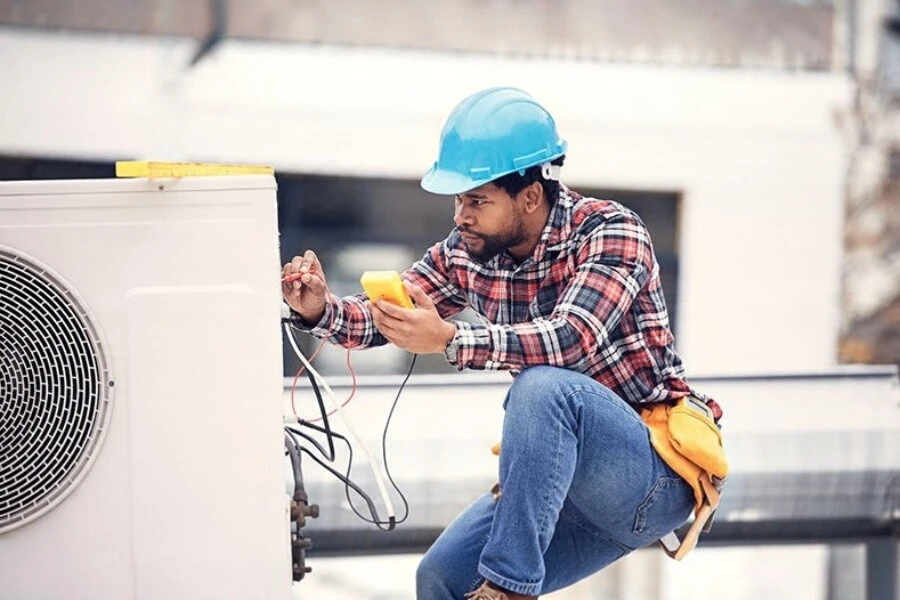 Royal AC technician servicing a home air conditioner